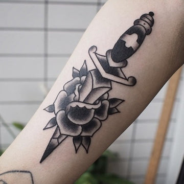 Black rose and dagger tattoo